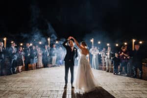 Aleisha and Mitchell sharing their first dance outside the marquee as guests wave sparklers at Growwild Wildflower Farm.