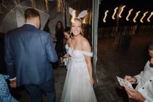 Bride Aleisha wearing sparkly bunny ears from the Growwild photo booth at her wedding reception.