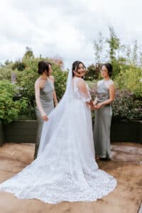Bride Cathy in her Luv Bridal gown, with her bridesmaids before her ceremony at Eden Gardens.