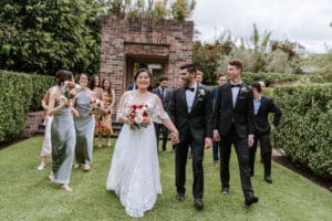 Bride Cathy and Groom Nick walking down the outdoor ceremony area at Eden Gardens in Macquarie Park.