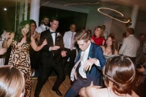 Friends and family having an incredible time dancing under the lights at Cathy and Nick's wedding reception at San Martin Akuna Bay.
