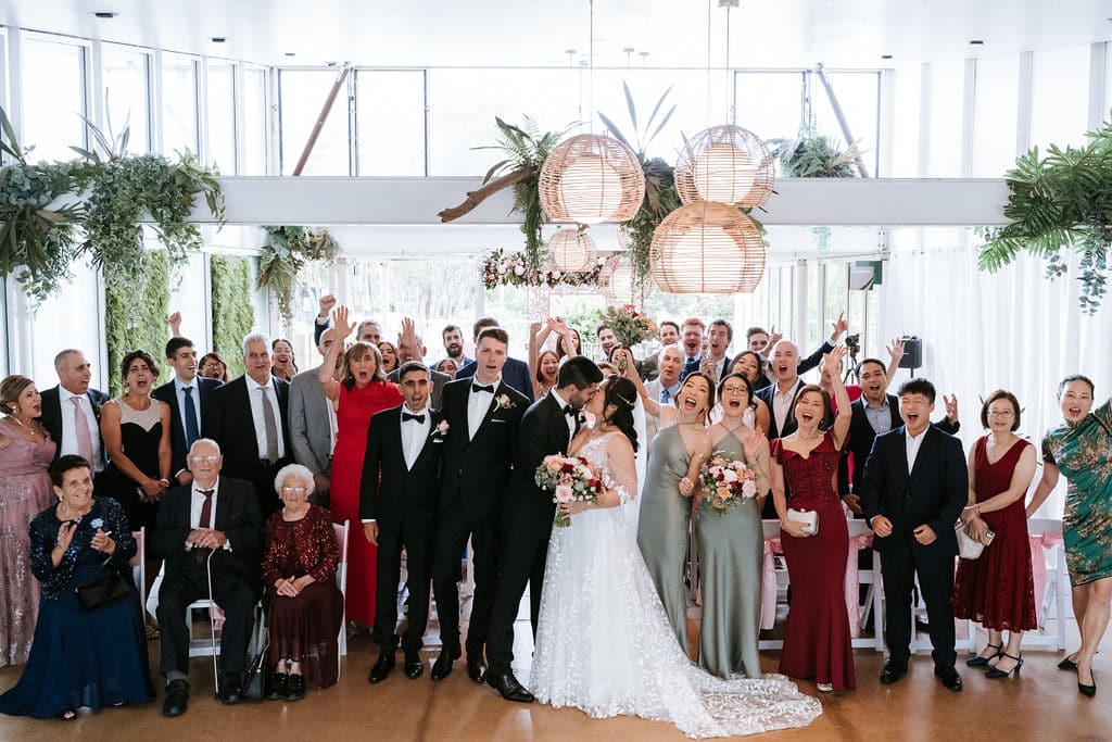 Newlyweds Cathy and Nick smiling and walking back down the aisle together after their Eden Gardens ceremony.