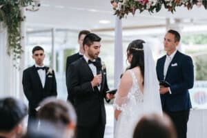 Bride Cathy and groom Nick exchanging wedding vows during their intimate outdoor ceremony at Eden Gardens, officiated by Jason Goode.